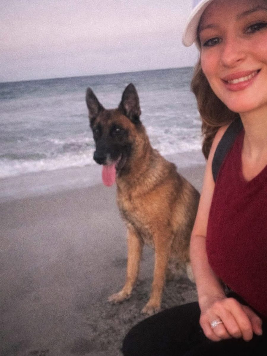 Michelle with a German Shepherd at the beach